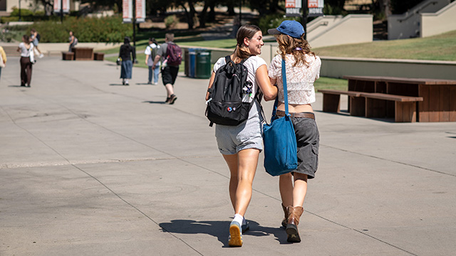 Two students walk along the Johnson Student Center Quad on the Occidental College campus.